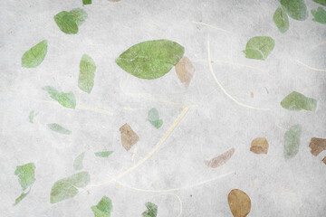 Handmade paper with pressed leaves and flower petals. Textured paper with natural fiber layers.    ...