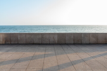 empty concrete floor with tranquil coastline. sky for large copy space.