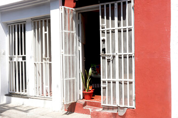 Typical houses in the neighborhoods of Cartagena with iron bars on the doors for greater security.