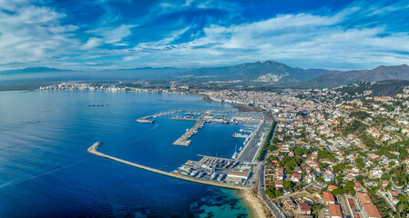Aerial view of the Golf of Roses in Spain with deep blue water, sky, sail boats