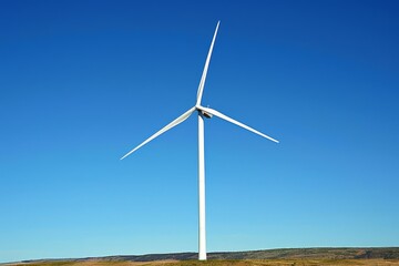 Wind turbine close-up with blades spinning against a clear blue sky Symbolizing renewable energy and sustainable technology