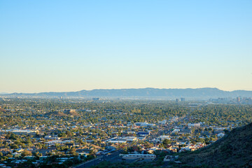 Arizona Valley of the Sun or Greater Phoenix Metro area as seen from North Mountain Park hiking trails toward South-East on late afternoon, copy space