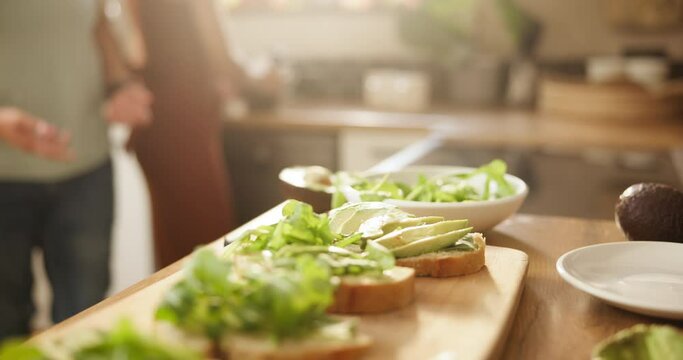 Hands, avocado and bread at table for sandwich with salad for health, diet and wellness for breakfast in home. People, toast and prepare fruit for nutrition, vegan meal and morning for food in house
