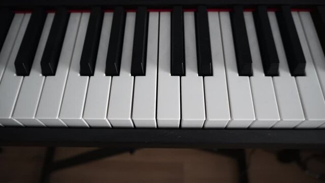 Closeup shot of the keyboard of a digital piano indoor in daylight with blur background