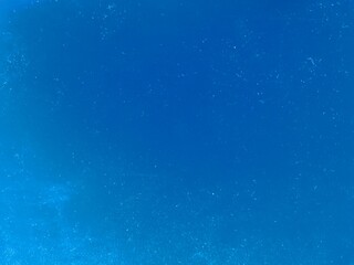 Abstract blue background with textured grainy surface.