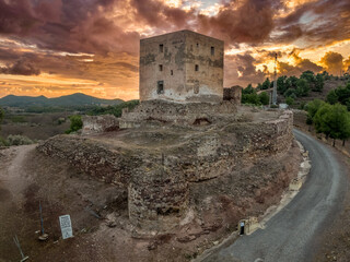 Torres Torres castle medieval hilltop stronghold in Spain with square tower and dramatic sunset sky