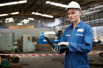 technician or engineer working on laptop computer in the factory