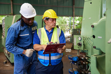 workers or technicians checking spare part and control lathe machine in the factory