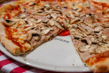 close up large Regina pizza on  arestaurant terrace table
