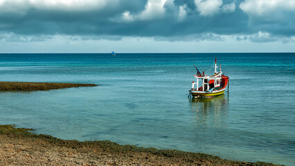 Fishing boat on the Ocean Horizon with Cloudy Sky