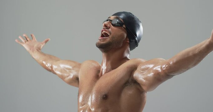 Exuberant young biracial athlete swimmer celebrates a victory in swimming