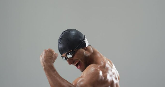 Athlete celebrating victory in a swimming cap and goggles