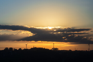 Naklejka premium Sunrise - Morning mood with dramatic clouds and warm rays of sunshine
