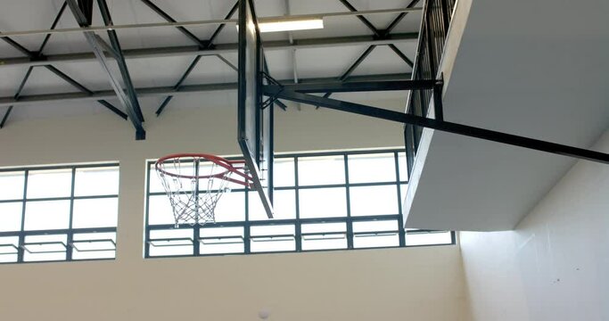 Indoor basketball hoop in a gymnasium, with copy space