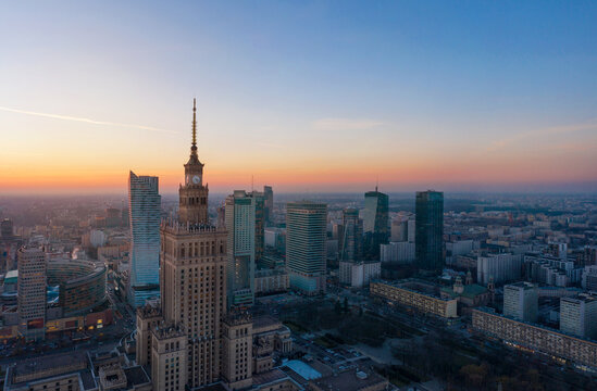 Aerial view of the business center of Warsaw: Palace of Science and Culture and skyscrapers in the evening © Erain