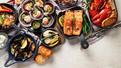 Set of Seafood dishes on light wooden background.