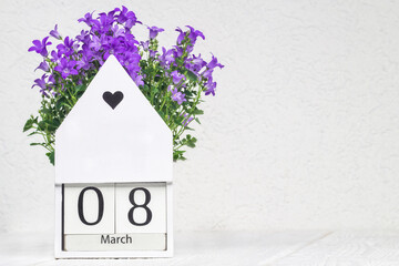 8 March wooden square shaped calendar.Women's day conceptual background with Campanula flower on...