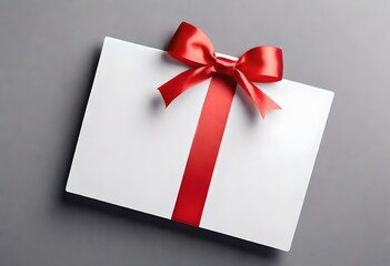 white gift box with a ribbon on plain wooden background grey