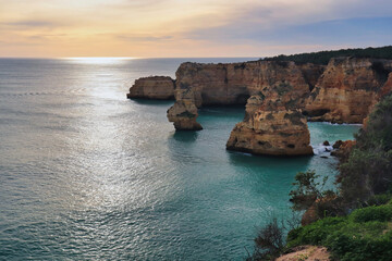 Beautiful coloful sky over the Atlantic Ocean and cliffs on a winter afternoon in southern Portugal.