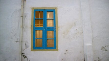 Fototapeta na wymiar old vintage wooden door and window with old vintage white crack wall
