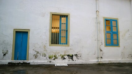 old vintage wooden door and window with old vintage white crack wall