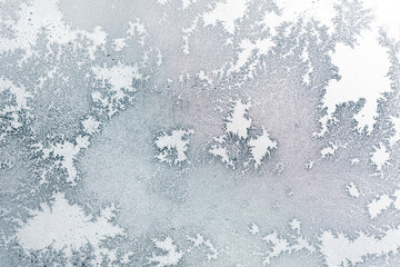 Frosty patterns on the window glass as a background