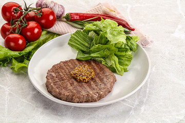 Frilled beef burger cutlet with iceberg