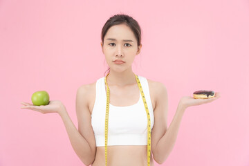 slim body Women choose during healthy foods and junk food, female choose green apple for diet. Good healthy food. weight lose, balance, control, reduce fat, low calories, routines, exercise.