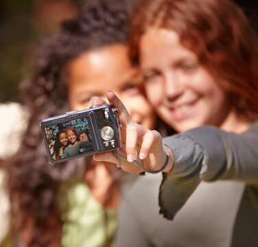 Happy girl, friends and selfie with camera in nature for memory or outdoor photography together. Young female person, child or kid with smile for picture, photo or social media in relax or friendship