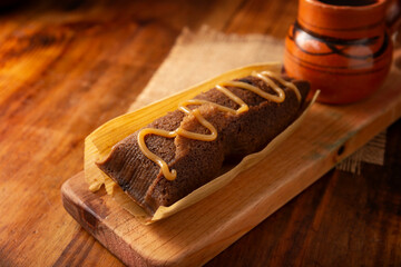 Chocolate Tamale. hispanic dish typical of Mexico and some Latin American countries. Corn dough wrapped in corn leaves. The tamales are steamed. Usually accompanied with atole, hot chocolate or coffee