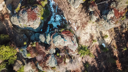 Aerial view of massive rock formation Grossofen surrounded by idyllic forest in Modriach, Hebalm, Kor Alps, border Carinthia Styria, Austria. Refreshing hiking trail in remote Austrian Prealps. Drone