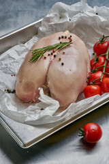 Fresh and raw chicken fillet are prepared for baking