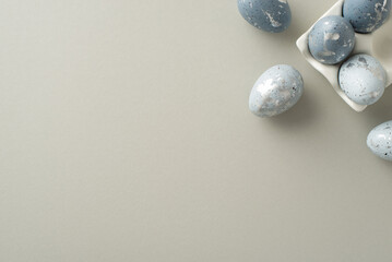 Easter setting capture: Top view of dove-grey eggs in an artisan ceramic case laid out on a pastel...