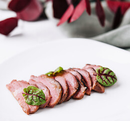 Sliced duck breast roasted meat on a plate