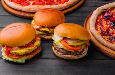 three different burgers and pizza top view