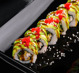 Avocado Sushi roll japanese food on black plate