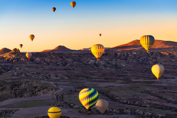 Colorful hot air balloons over Goreme, Cappadocia, Turkey. Beautiful landscape at sunrise.