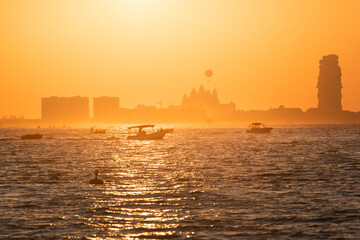 Dubai beach at sunset. View of the Persian Gulf with boats.