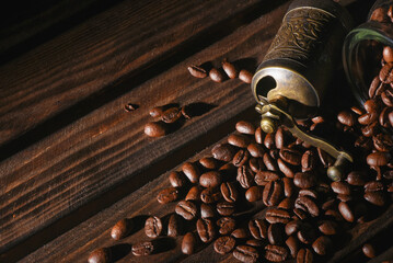 Coffee beans and coffee grinder on the kitchen table close up background. Front view.