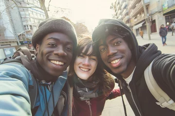 Foto op Plexiglas Selfie of young multiracial friends taking a selfie outdoors with backlight - A happy life style friendship concept on young multiracial best friends having fun in Barcelona city - Warm vivid filter © Zaleman