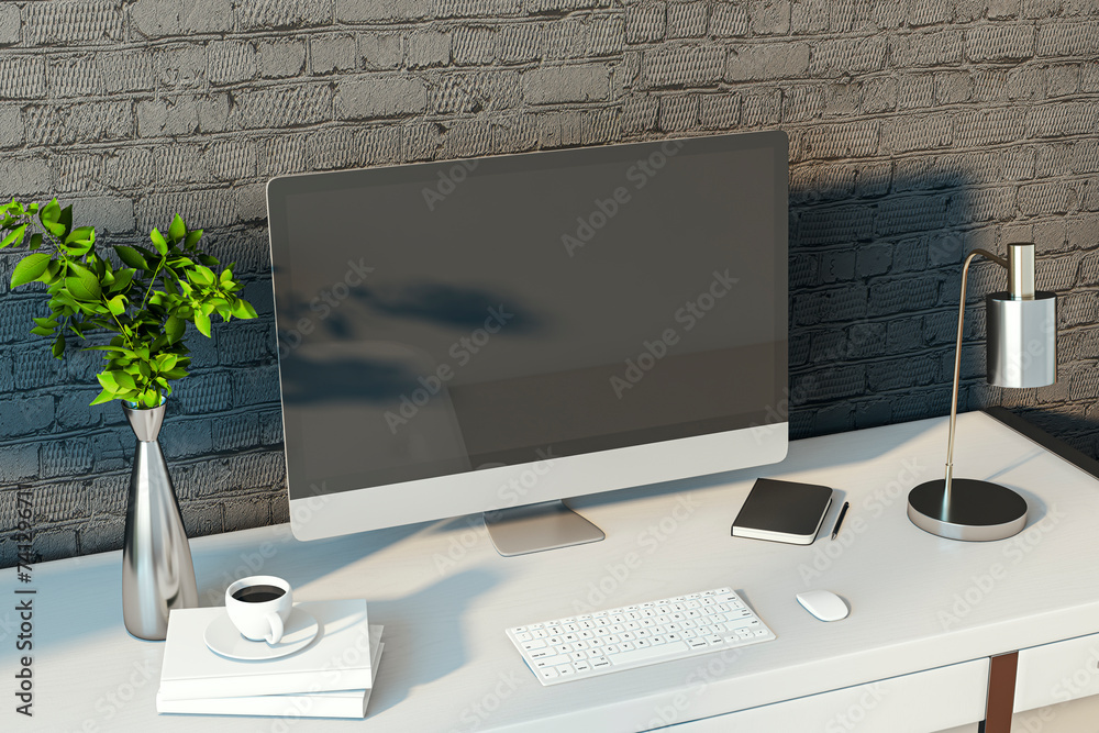 Poster creative designer desktop with empty computer monitor, lamp, supplies and other items. black brick w