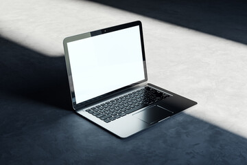 Open laptop on a concrete background with natural lighting, clean design technology mockup. 3D Rendering