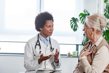 Doctor specialist consulting a patient at the clinic. A female doctor is talking with a female...