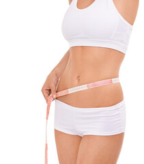 Woman, abdomen and tape in studio for health, measuring and fitness for weight loss. Female person, results on progress and nutrition for slim body, stomach and workout closeup with white background