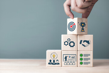 Concepts and methods for developing organizations towards success. Business icons on wooden blocks...