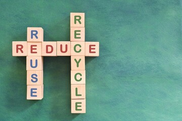 Reduce reuse recycle problem solving, solution and strategy concept. Crossword flat lay composition in green background. 