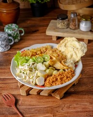 Ketoprak uses the main ingredients are tofu, ketupat or lontong, bean sprouts, crackers. You can also add boiled eggs. doused with peanut sauce, sweet soy sauce, and a sprinkling of fried shallots.