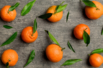 Many fresh ripe mandarin as colored background, top view. Elegant background of clementines and...