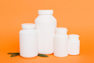 supplement pills with medicine bottle health care and medical top view. Vitamin tablets. Top view mockup bottle for pills and vitamins with green leaves, natural organic bio supplement, copy space