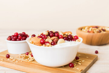 Healthy breakfast food with granola, yogurt, fruits and nuts. Dessert parfait with dried fruits for breakfast